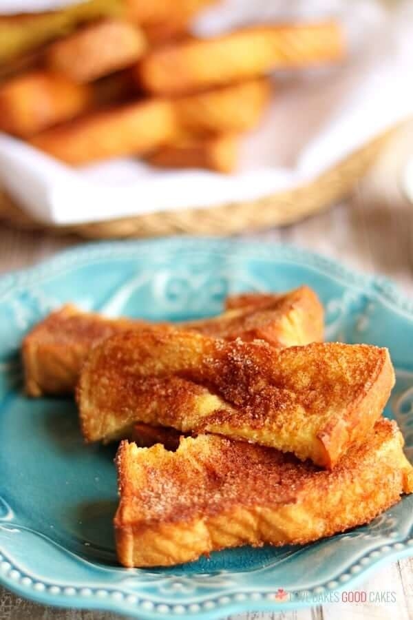 A plate of three crispy French toast sticks.