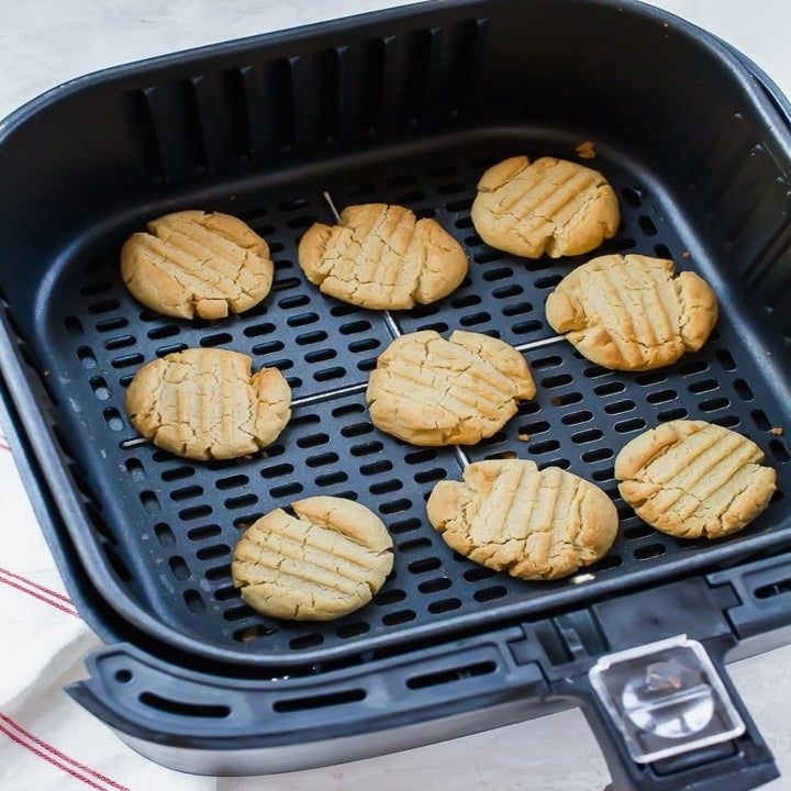 Cookies in the basket of an air fryer.
